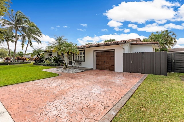 view of front of house with a front yard and a garage