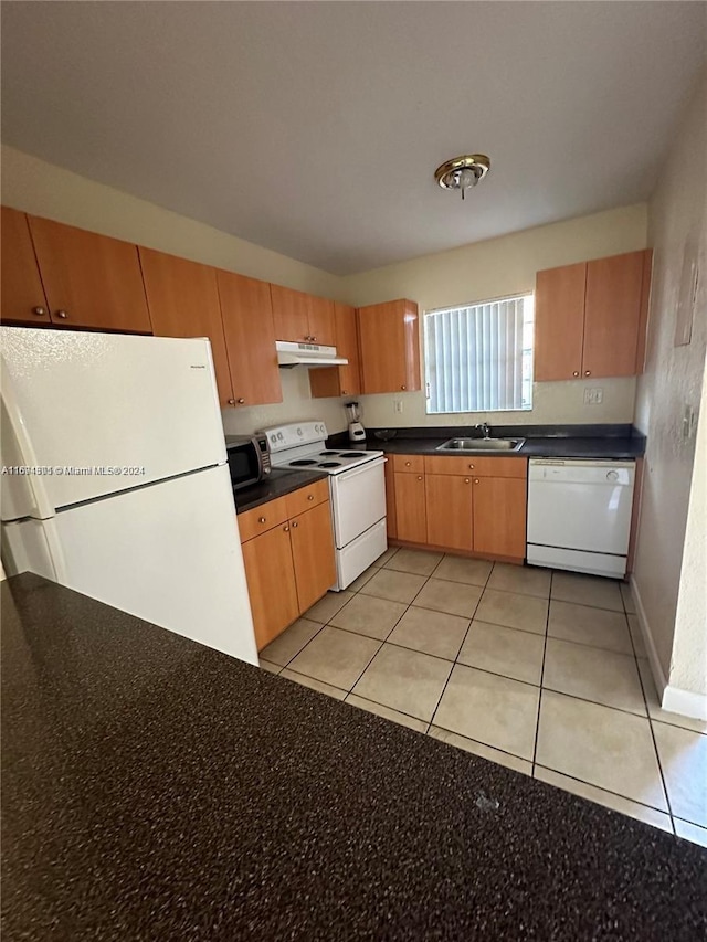 kitchen featuring sink, light tile patterned floors, and white appliances