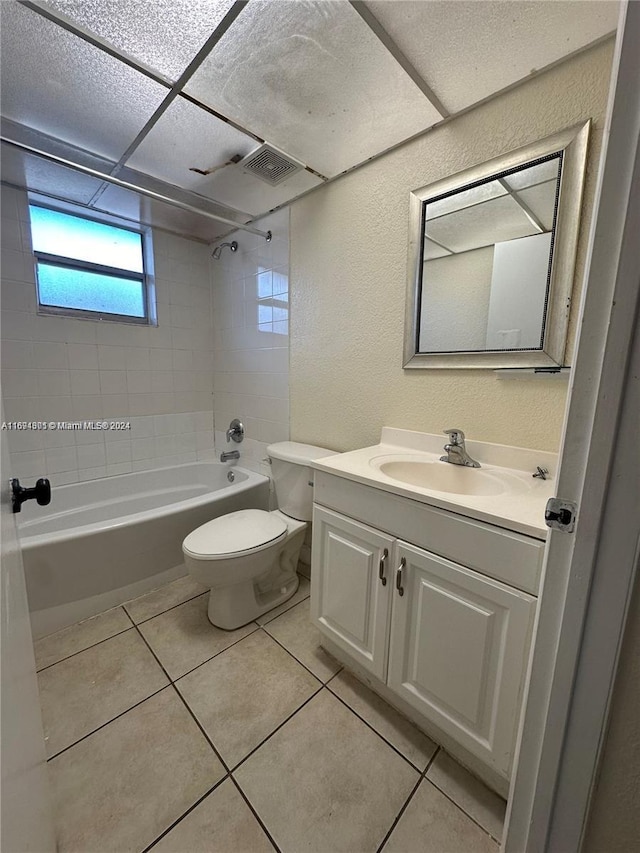 full bathroom with toilet, vanity, tiled shower / bath combo, and tile patterned floors