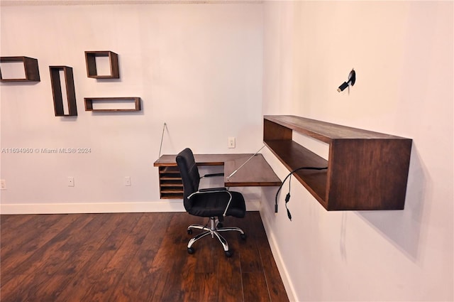 home office with built in desk and hardwood / wood-style flooring