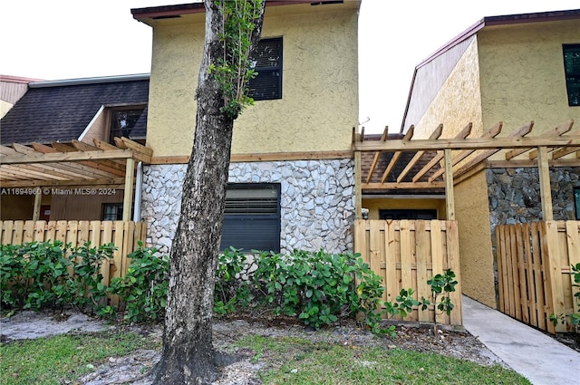 view of side of home with a pergola