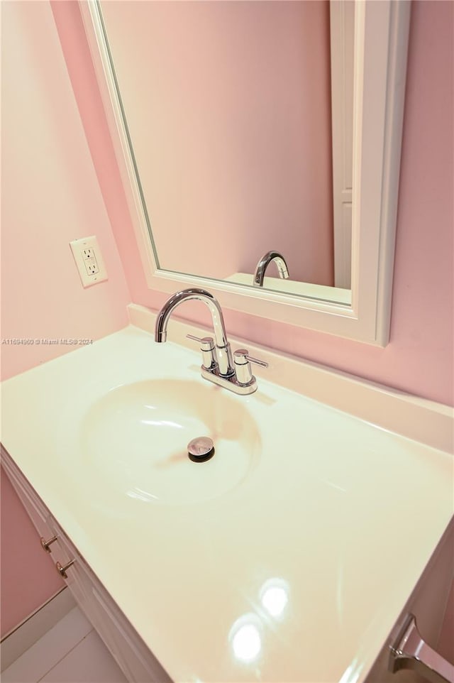 bathroom with tile patterned flooring and vanity