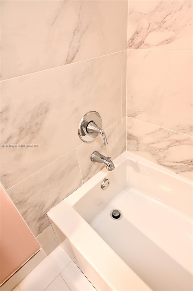 bathroom featuring tile patterned floors and tile walls