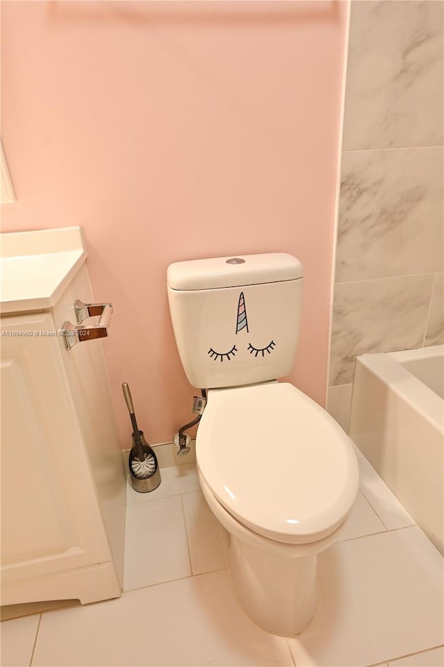 bathroom featuring tile patterned flooring, a bathtub, and toilet