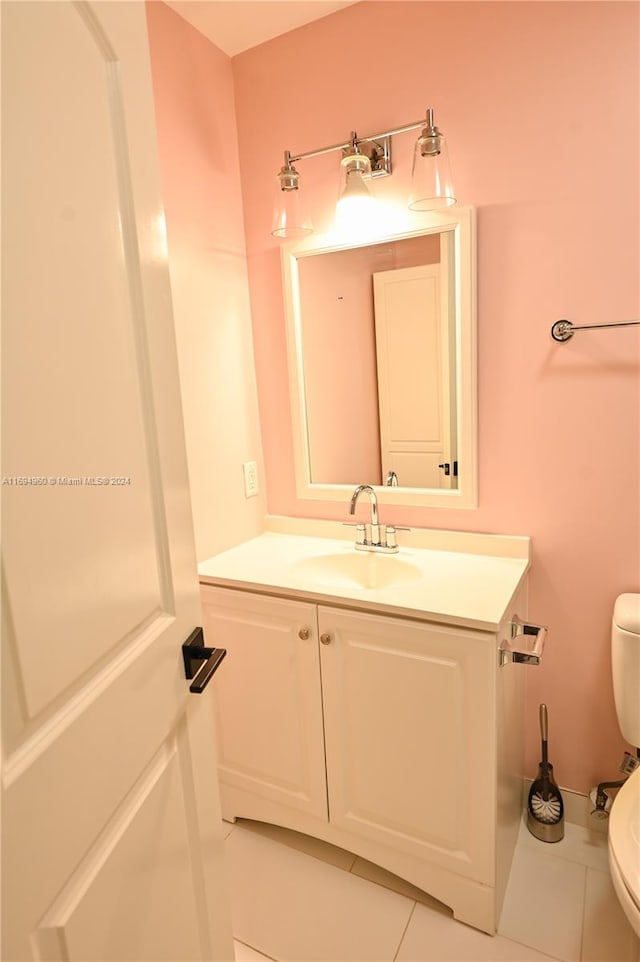 bathroom with tile patterned floors, vanity, and toilet