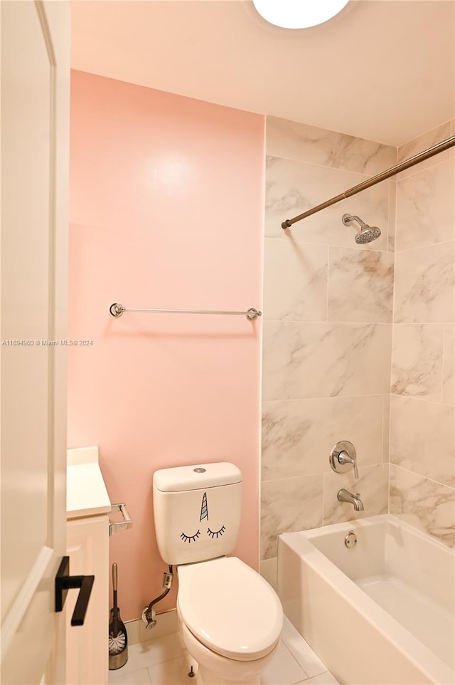 bathroom with toilet, tiled shower / bath combo, and tile patterned floors