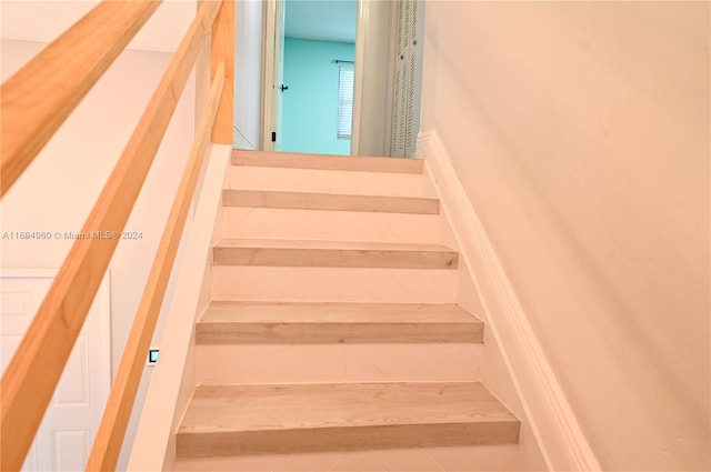 stairs featuring tile patterned flooring