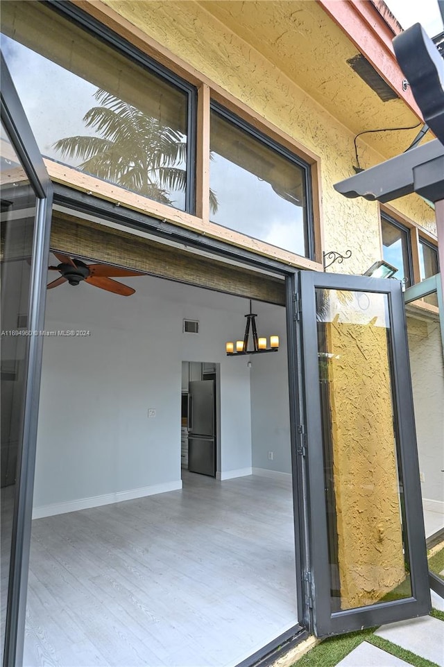 property entrance with ceiling fan