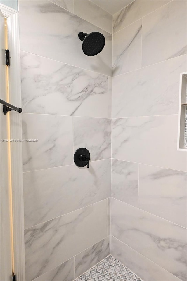 bathroom with a tile shower