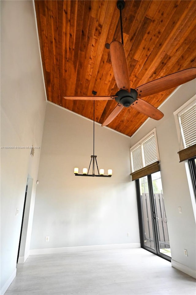 spare room featuring ceiling fan with notable chandelier, wood ceiling, high vaulted ceiling, and light hardwood / wood-style flooring