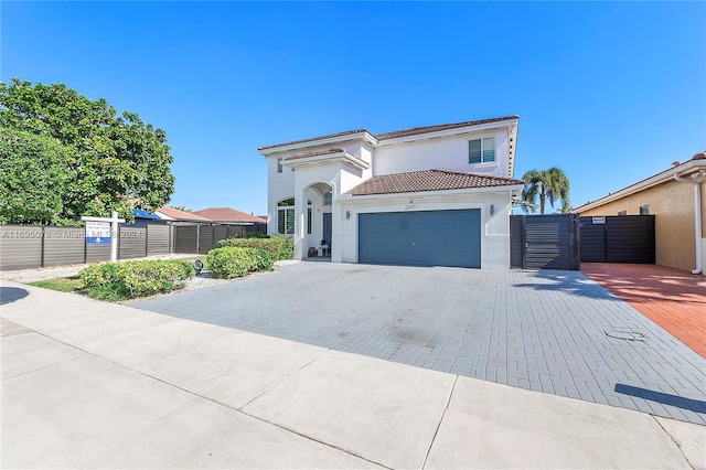 mediterranean / spanish-style house with a garage