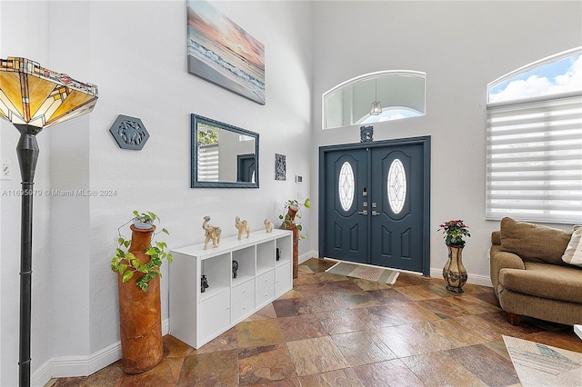 foyer entrance with a towering ceiling