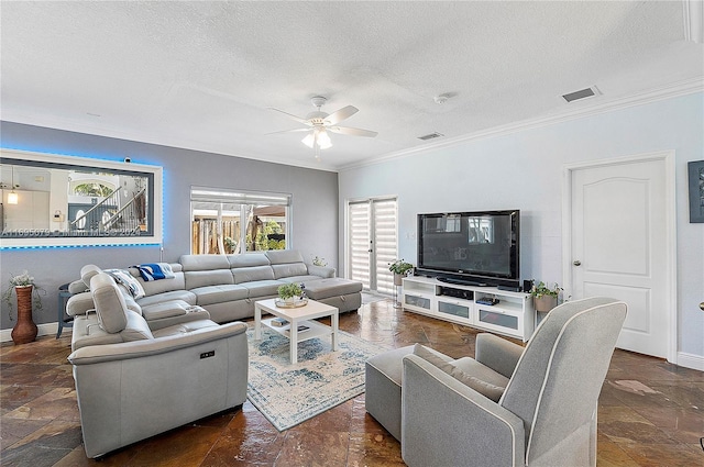 living room with a textured ceiling, ceiling fan, and crown molding