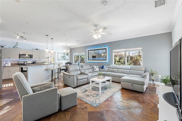 living room with ceiling fan with notable chandelier, a textured ceiling, and ornamental molding