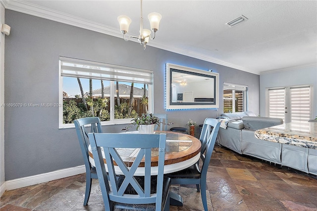 dining space with a chandelier, a healthy amount of sunlight, and ornamental molding