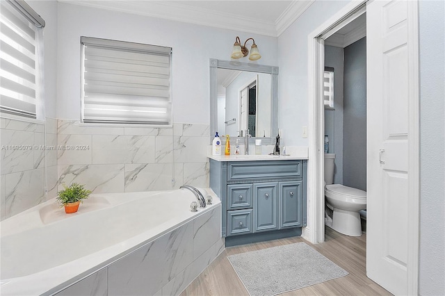 bathroom with vanity, hardwood / wood-style flooring, toilet, ornamental molding, and tiled tub