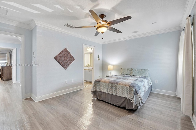 bedroom with ceiling fan, light wood-type flooring, crown molding, and ensuite bath