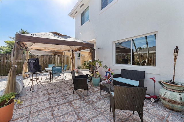 view of patio featuring outdoor lounge area and a gazebo