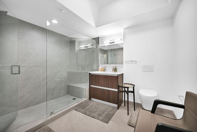 bathroom featuring tile patterned flooring, vanity, toilet, and a shower with door