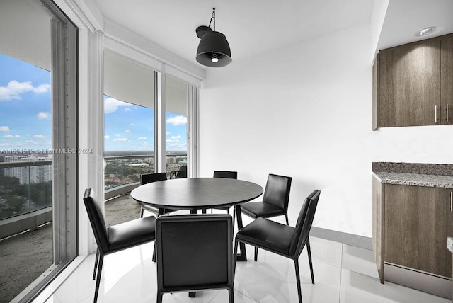 dining space featuring light tile patterned floors