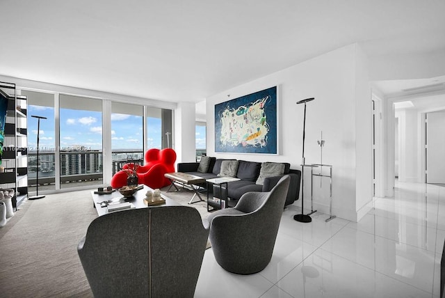 living room featuring light tile patterned floors and a wall of windows