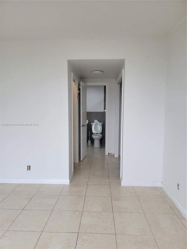 hallway with light tile patterned floors