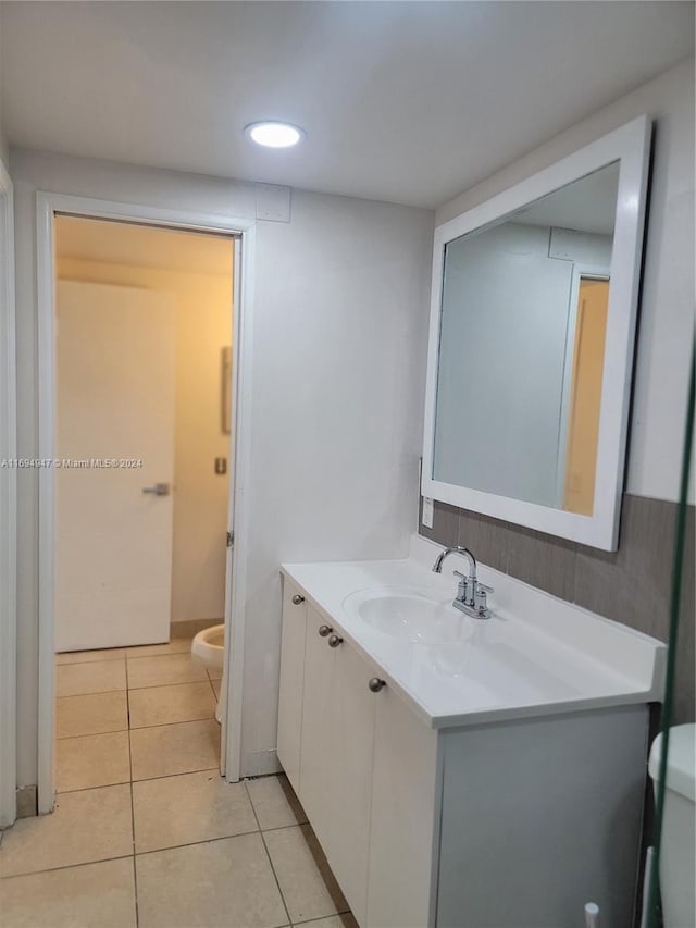 bathroom featuring tile patterned floors, vanity, and toilet