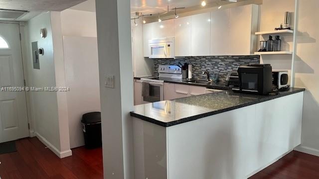 kitchen featuring stainless steel electric range oven, sink, tasteful backsplash, dark hardwood / wood-style floors, and white cabinets