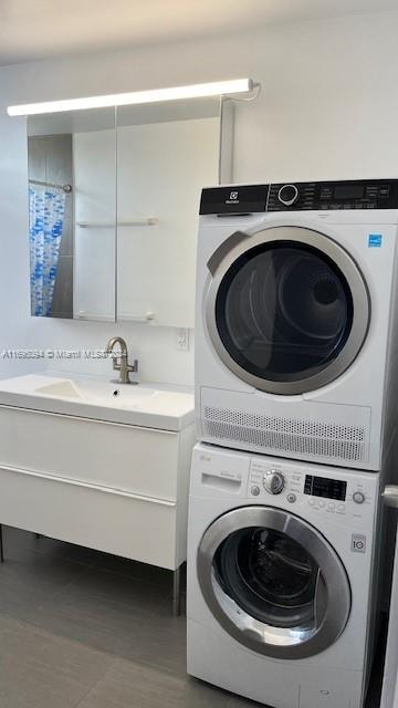 washroom featuring stacked washing maching and dryer