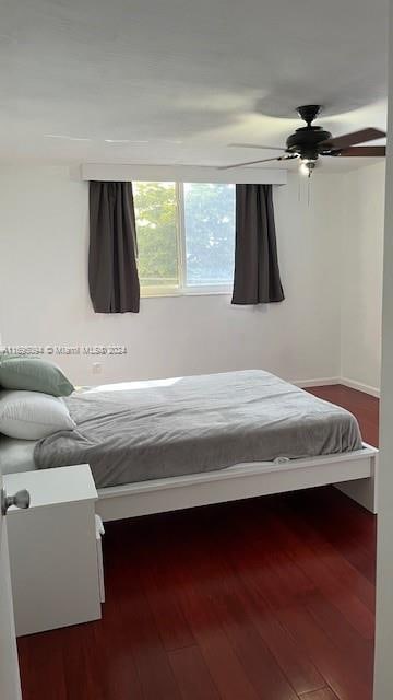 bedroom featuring dark hardwood / wood-style floors and ceiling fan