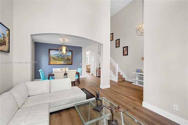 living room featuring wood-type flooring and a high ceiling