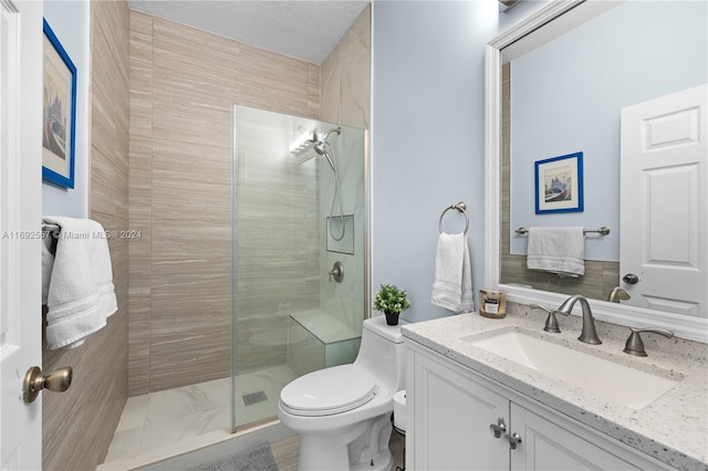 bathroom with vanity, a shower with shower door, a textured ceiling, and toilet