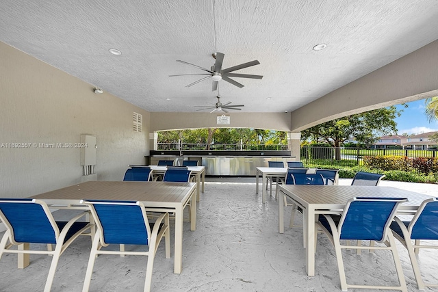 view of patio / terrace with ceiling fan and an outdoor bar