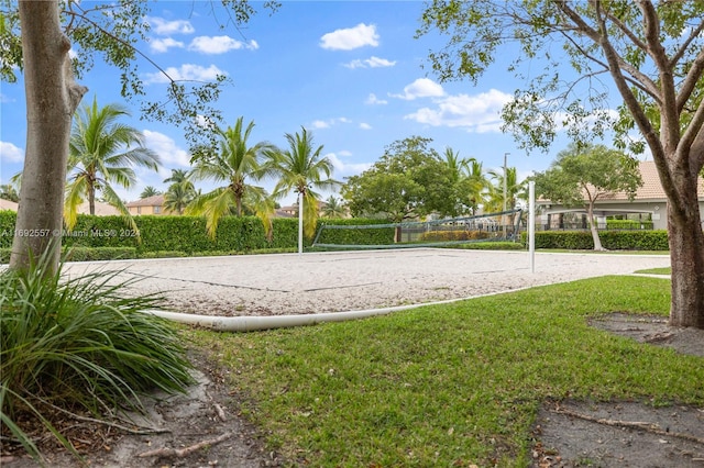 view of home's community featuring a lawn and volleyball court