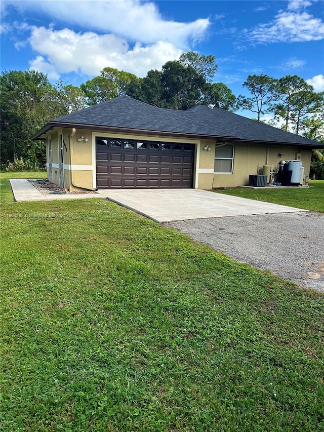 single story home featuring a garage, central air condition unit, and a front yard