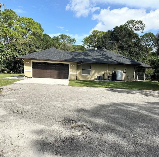 ranch-style house with cooling unit and a garage