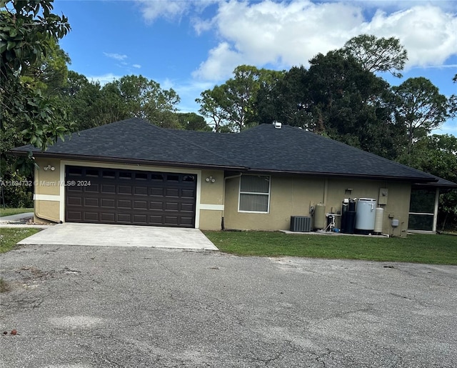 single story home with a garage and a front lawn