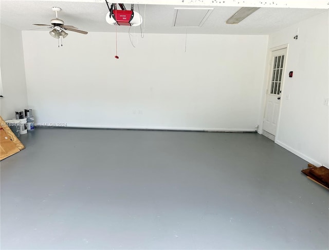 garage with a garage door opener and ceiling fan