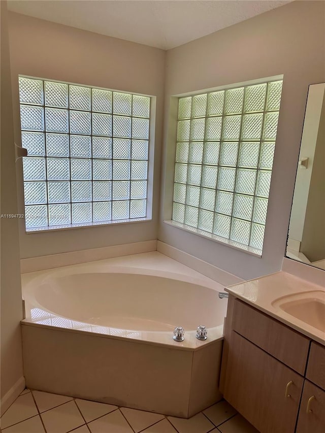 bathroom featuring tile patterned floors, a bathtub, and vanity