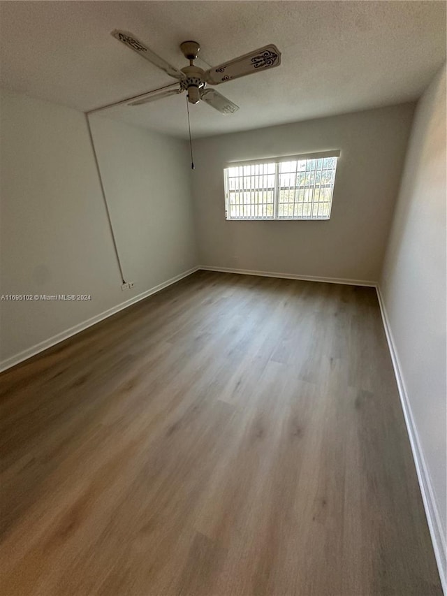 unfurnished room featuring ceiling fan, a textured ceiling, and hardwood / wood-style flooring