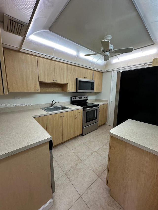 kitchen featuring stainless steel appliances, ceiling fan, sink, light brown cabinets, and light tile patterned floors