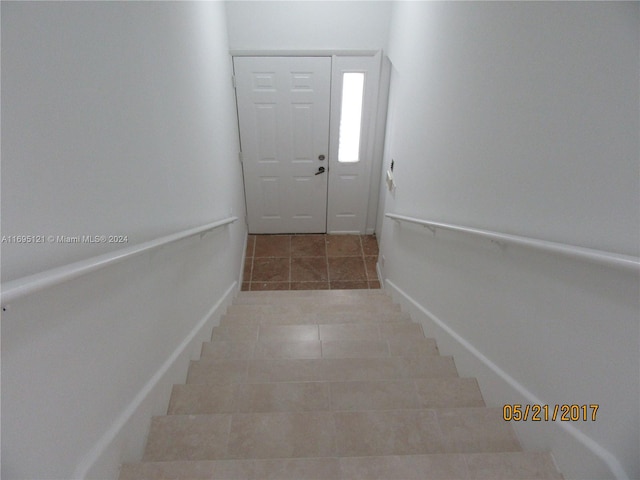 stairway featuring tile patterned floors