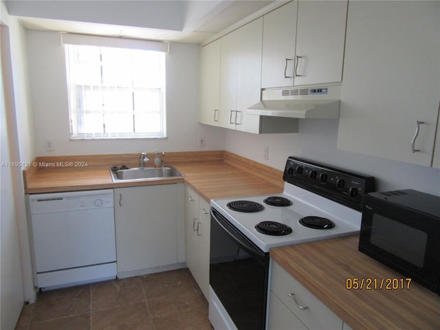 kitchen with white cabinets, white appliances, butcher block countertops, and sink