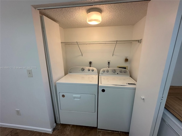 laundry area featuring baseboards, laundry area, dark wood-style flooring, a textured ceiling, and independent washer and dryer