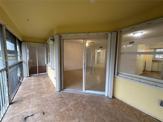 unfurnished sunroom with visible vents