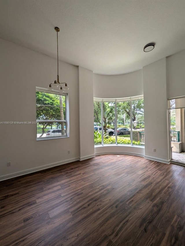 empty room with dark hardwood / wood-style floors