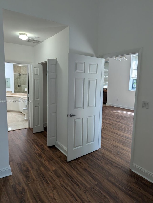 hallway with dark hardwood / wood-style flooring