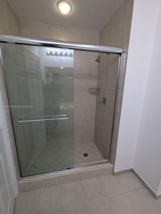 bathroom featuring tile patterned flooring and walk in shower