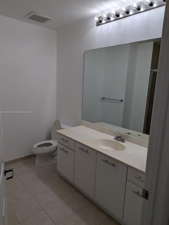 bathroom with tile patterned floors, vanity, and toilet