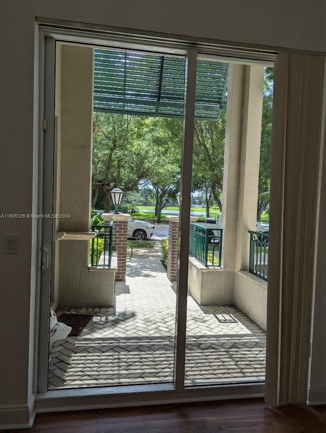 doorway to outside with hardwood / wood-style floors and a wealth of natural light